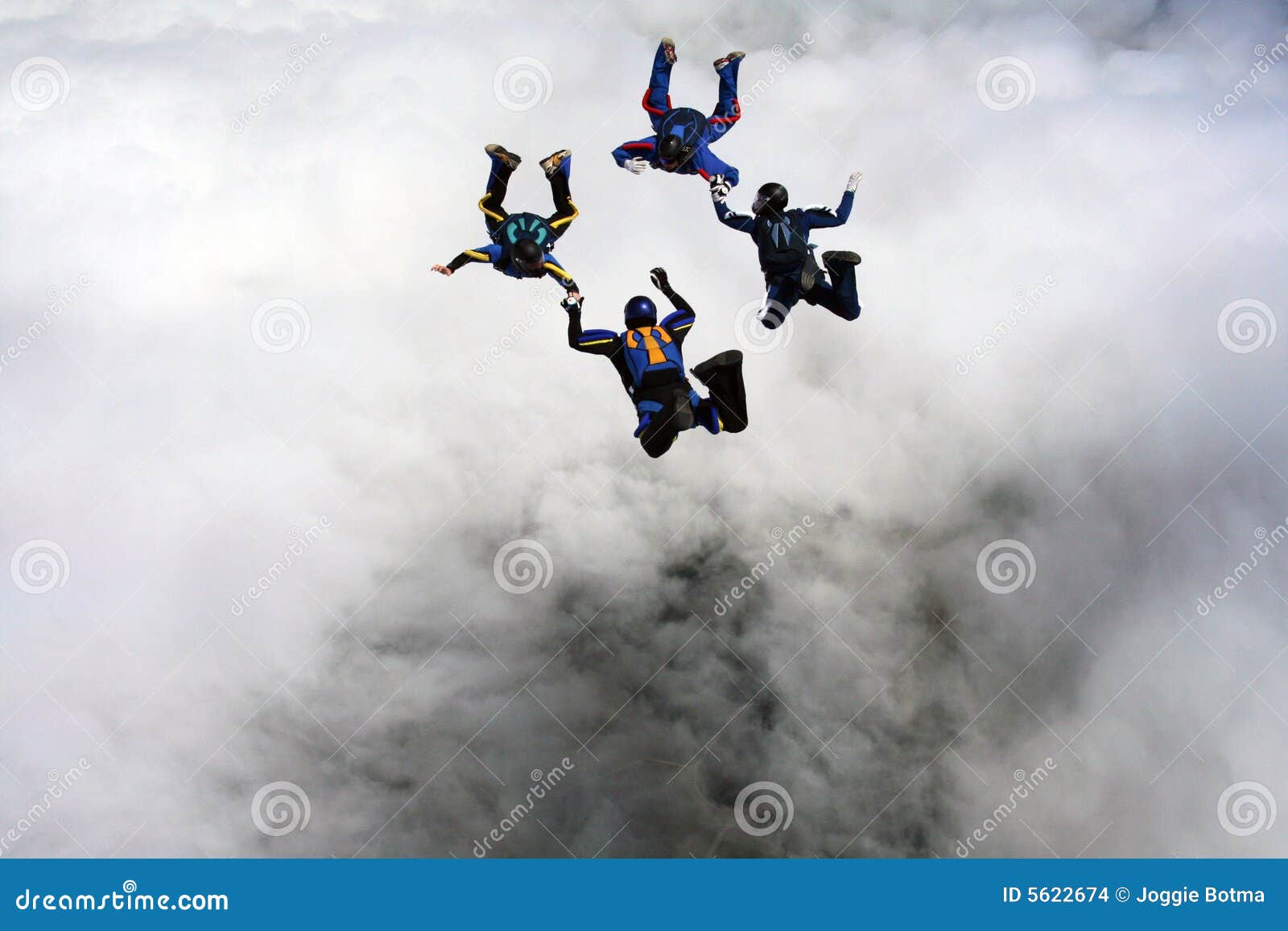 four skydivers building a star formation