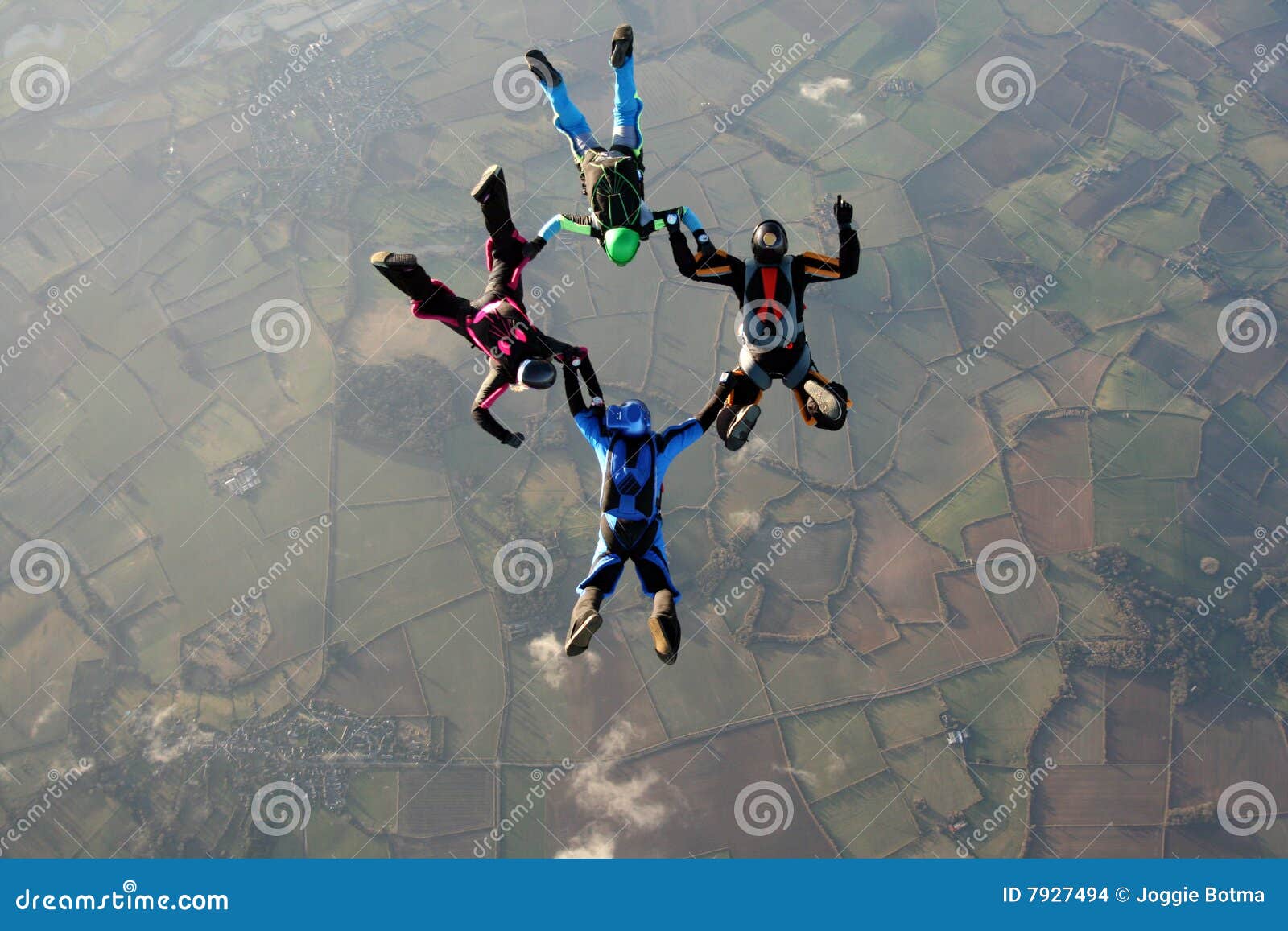 four skydivers doing formations