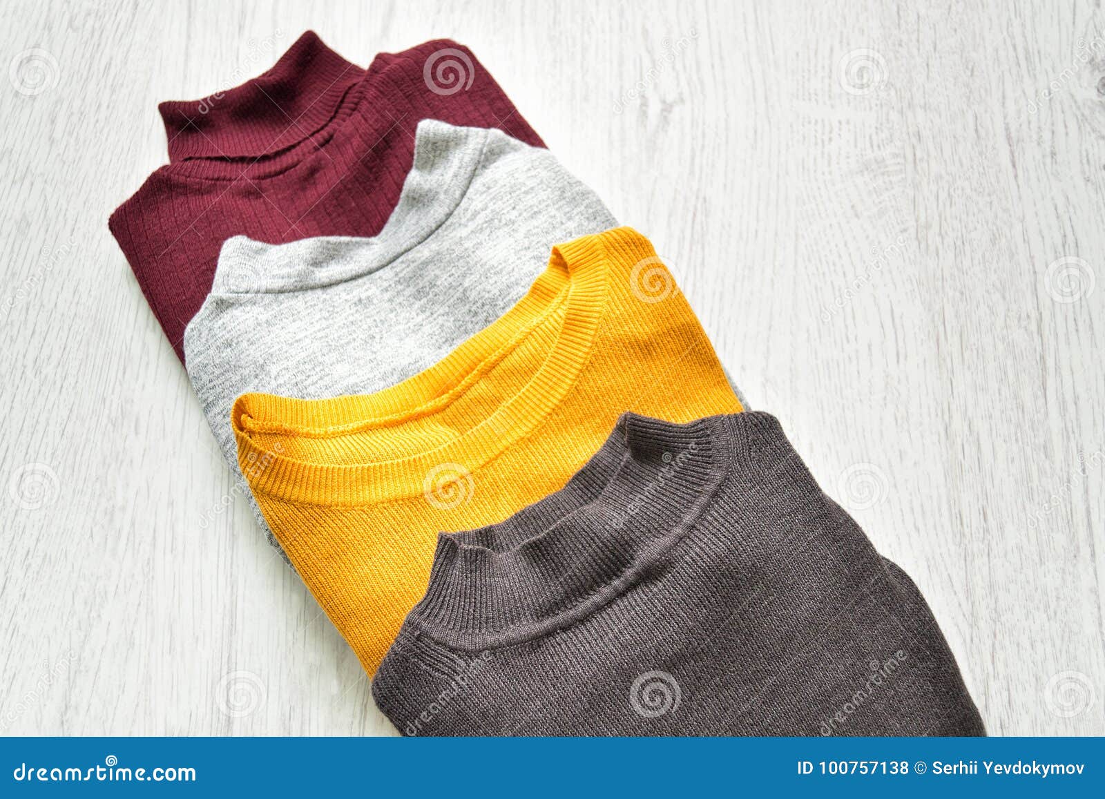 Four Sweaters on a Wooden Background. Fashion Concept Stock Photo ...