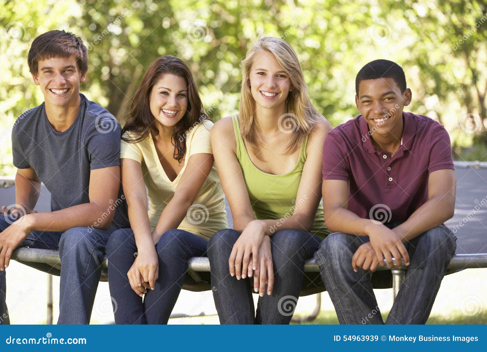 Four Teenage Friends Sitting on Trampoline in Garden Stock Image ...