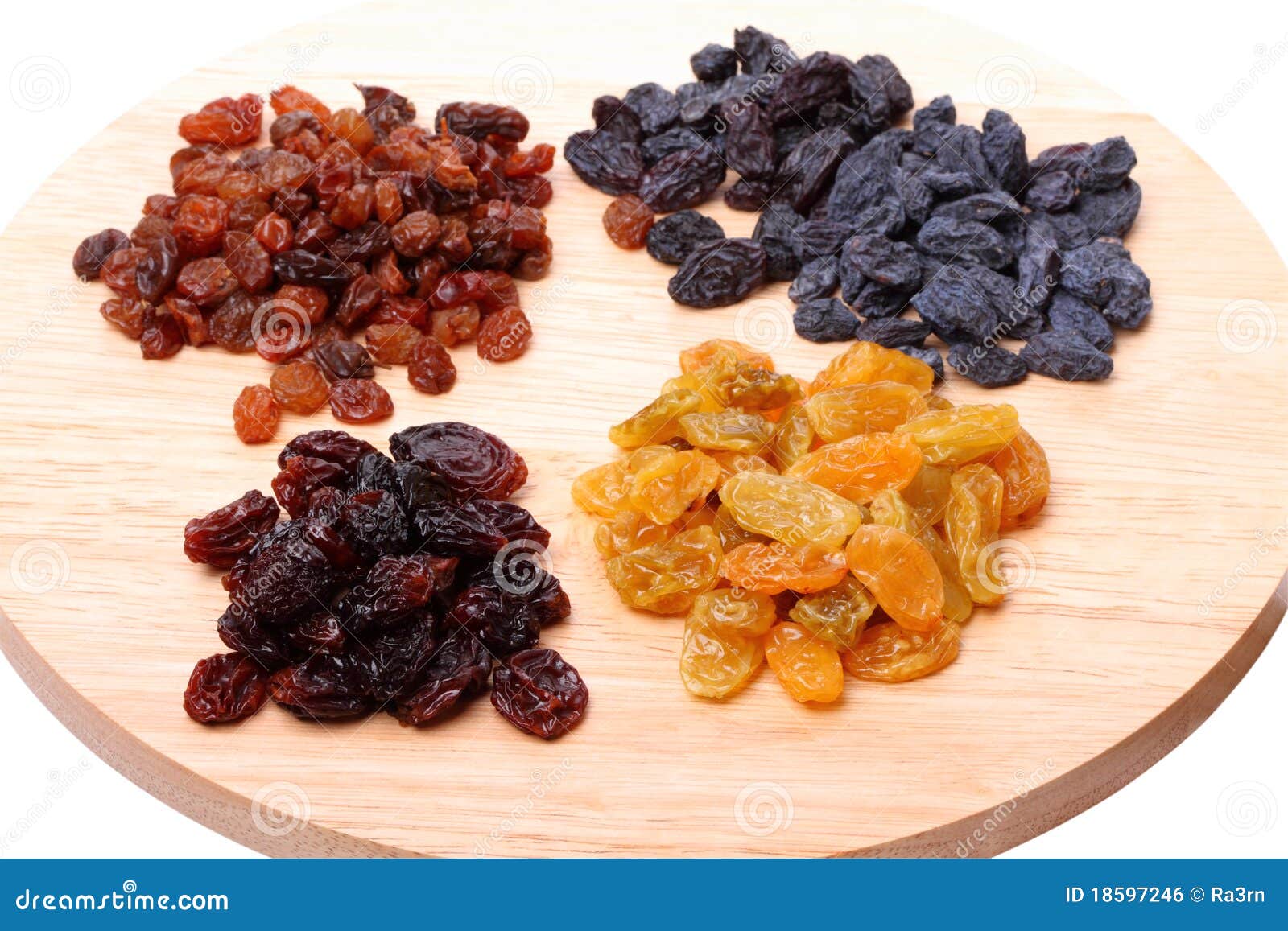 Four Variety Of Raisins On A Cutting Board Royalty Free Stock Image