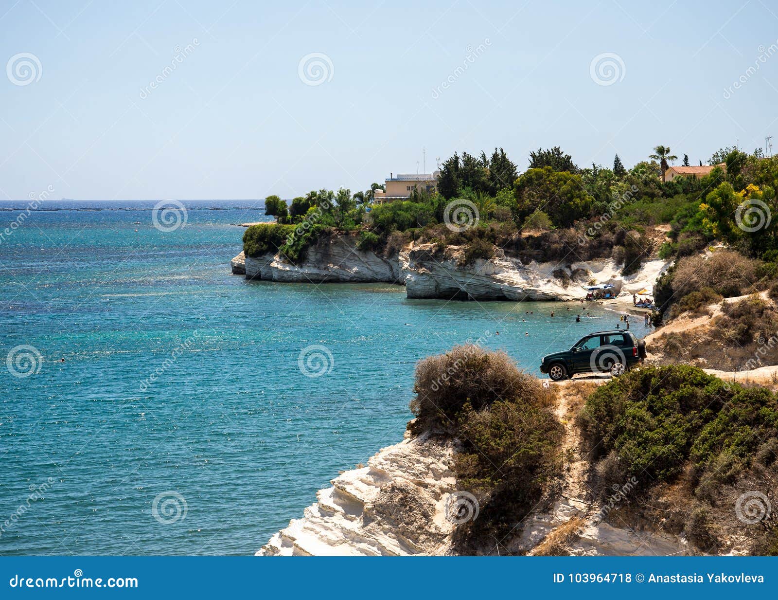 a four wheel drive car dangerously parked next to steep cliff at governor`s beach, cyprus