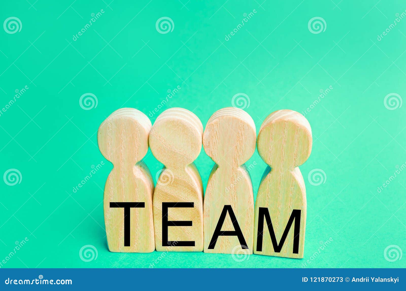 four wooden people with the inscription `team`. group work. teamwork. achievement of goals, corporate spirit. cohesion in the team