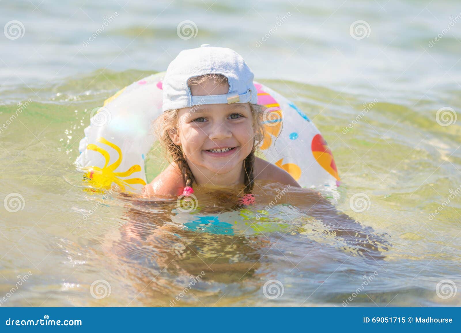 Four-year Girl Floats with a Circle in the Sea Water Stock Image ...