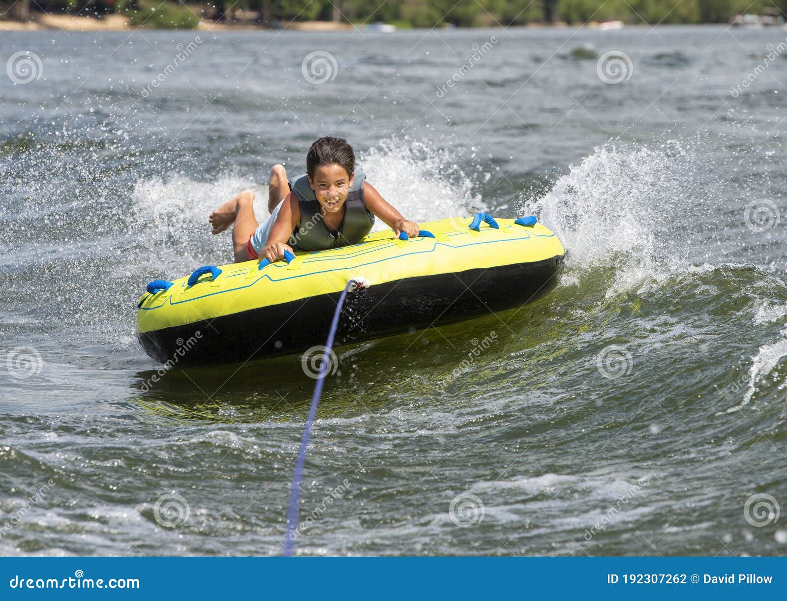 fourteen year-old amerasian boy tubing on grand lake in oklahoma.