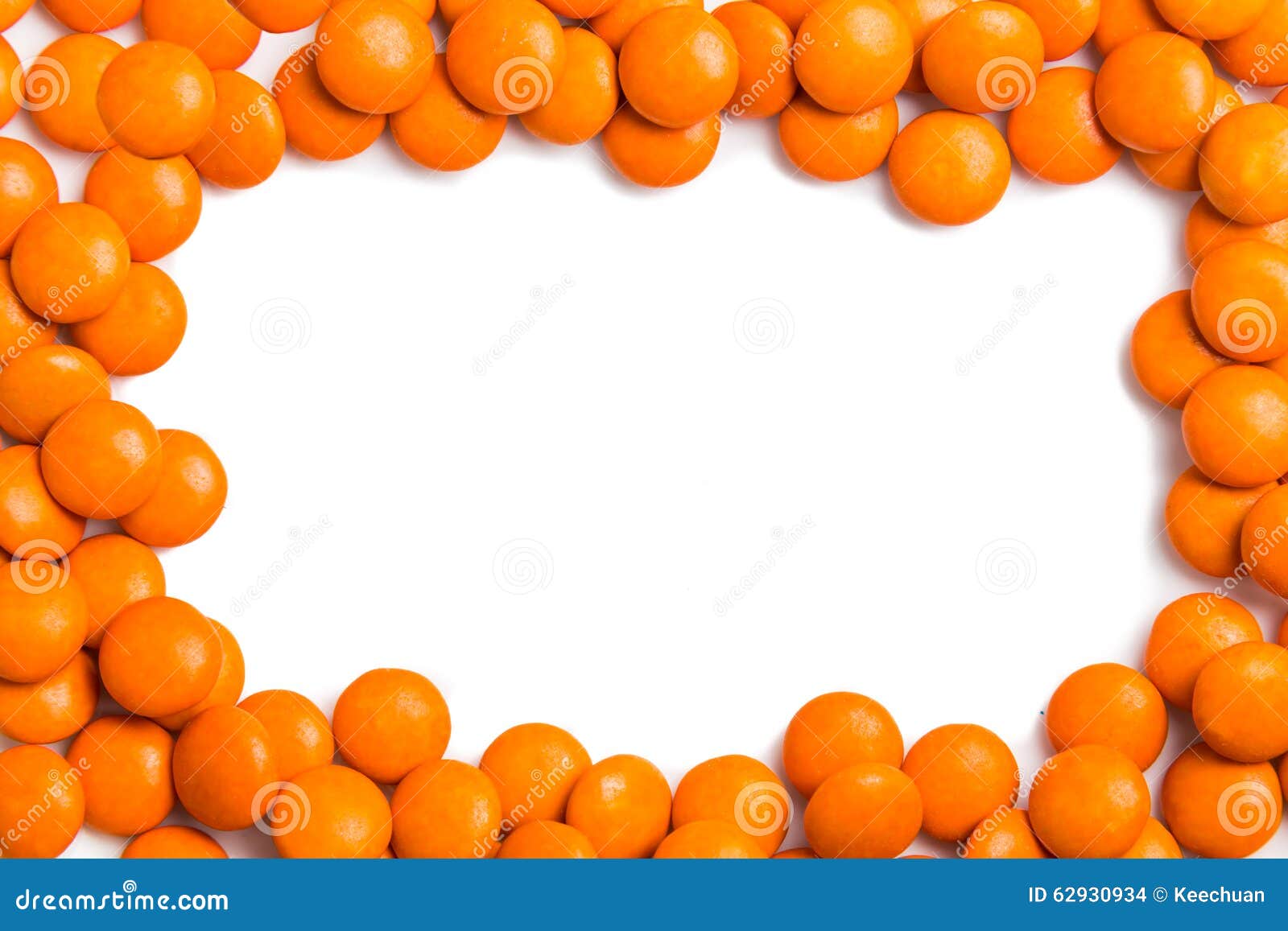Frame of Orange Chocolate Candy on White Background with Space Stock