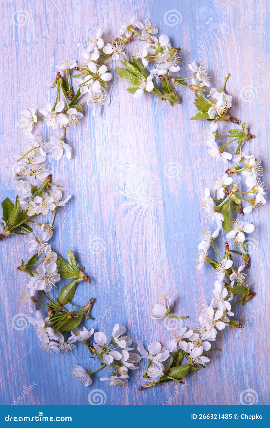 Frame of Spring Flowers on the Background of Old Vintage Blue Board