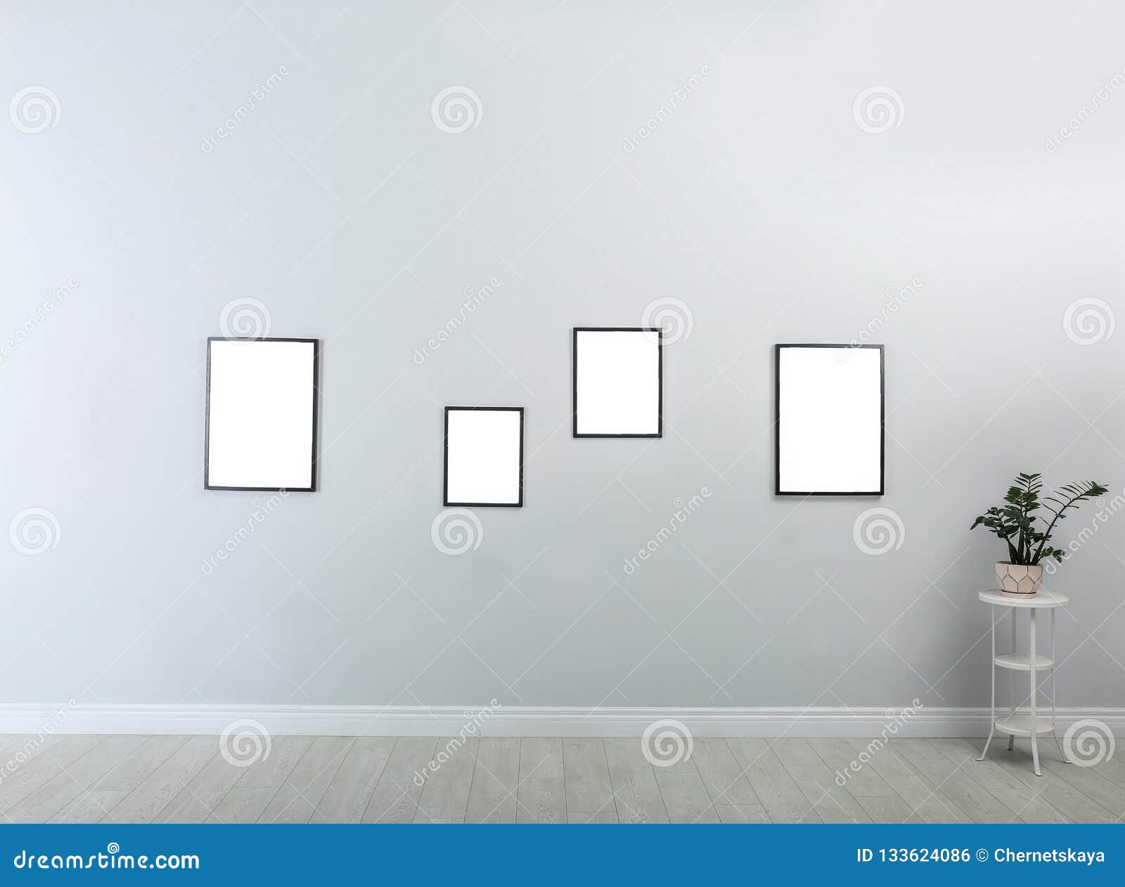 Frames with Empty Canvases on Wall in Modern Art Gallery Stock Photo