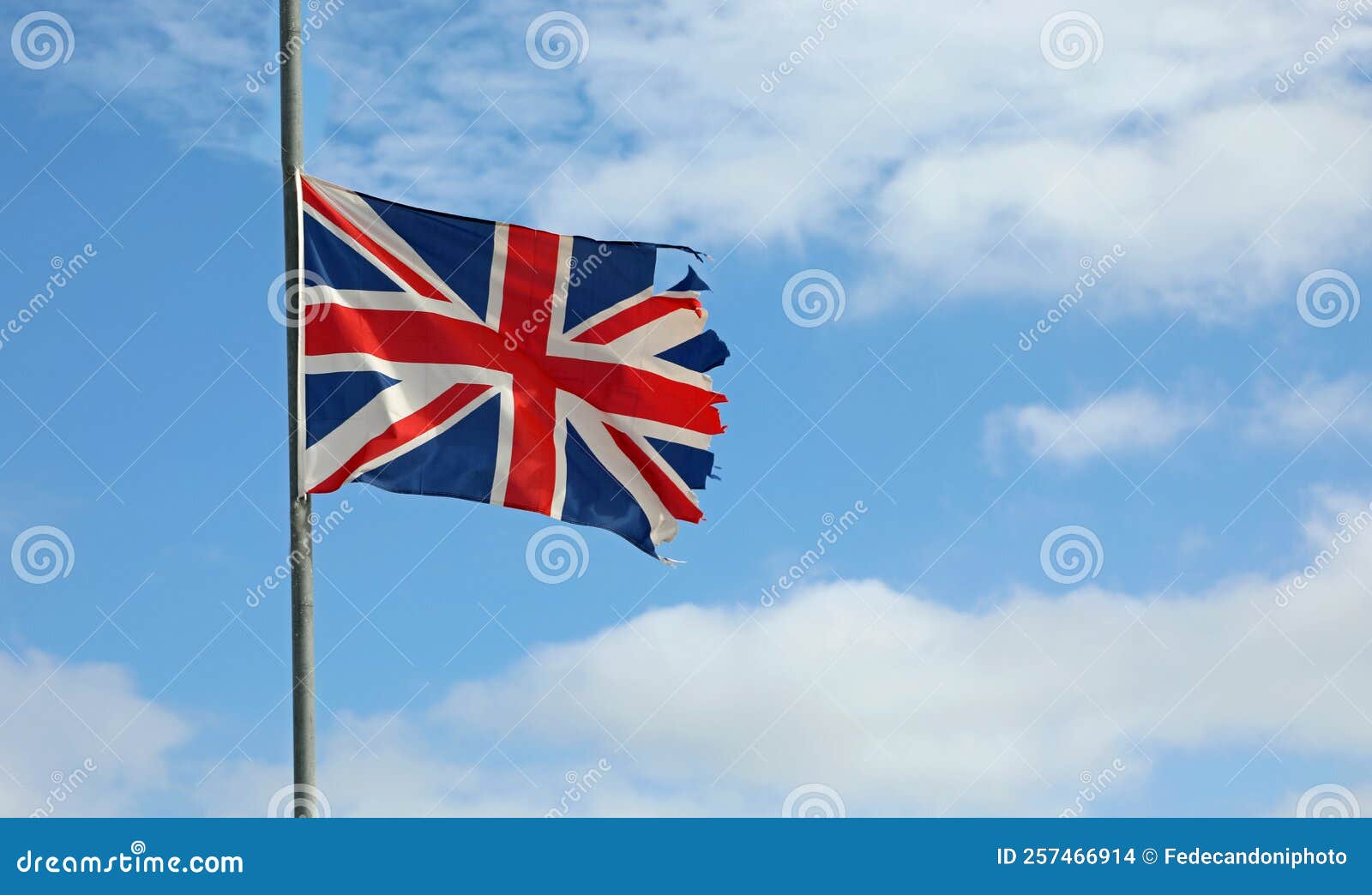 frayed english flag at half mast