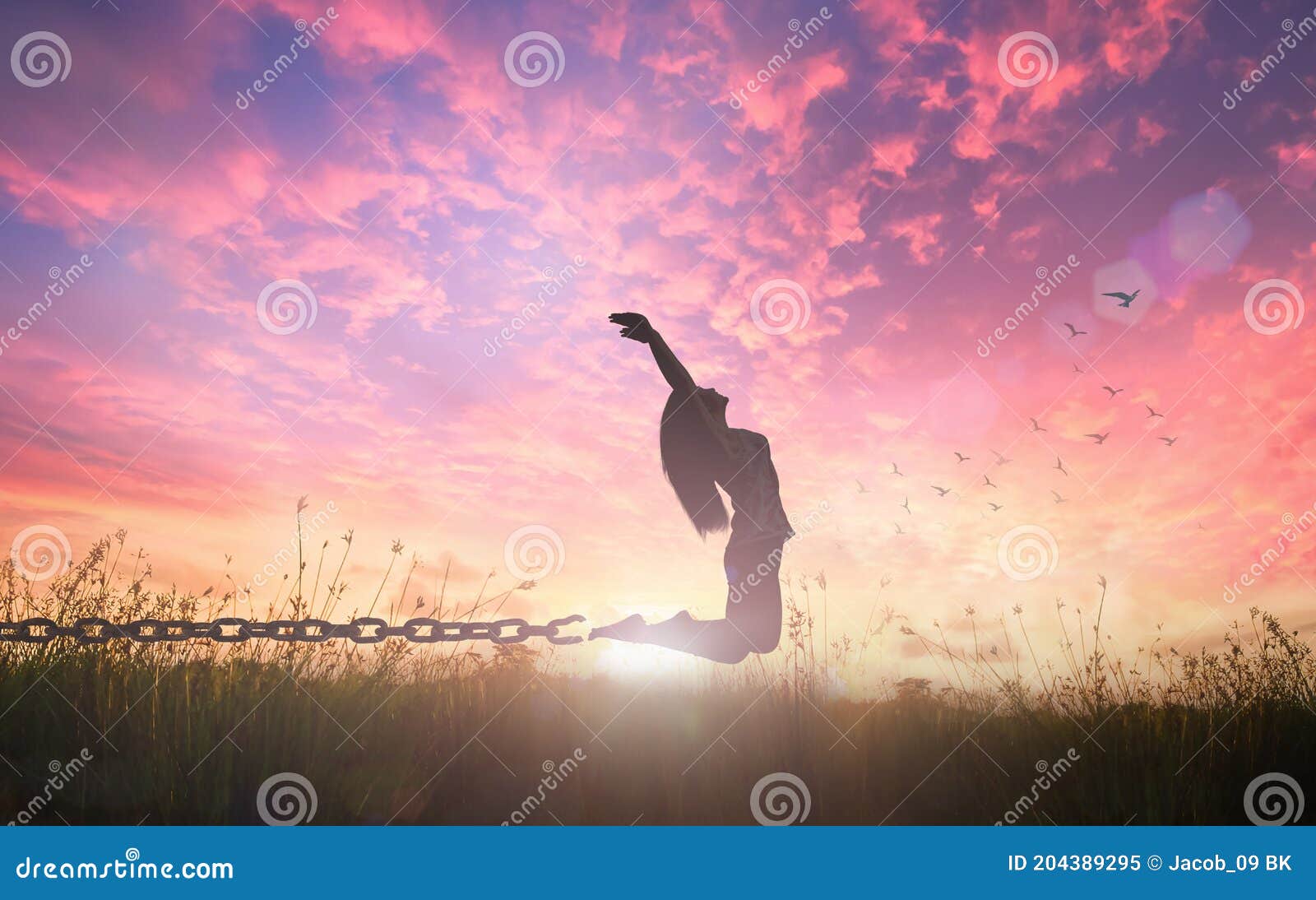 freedom concept of woman jumping and broken chains