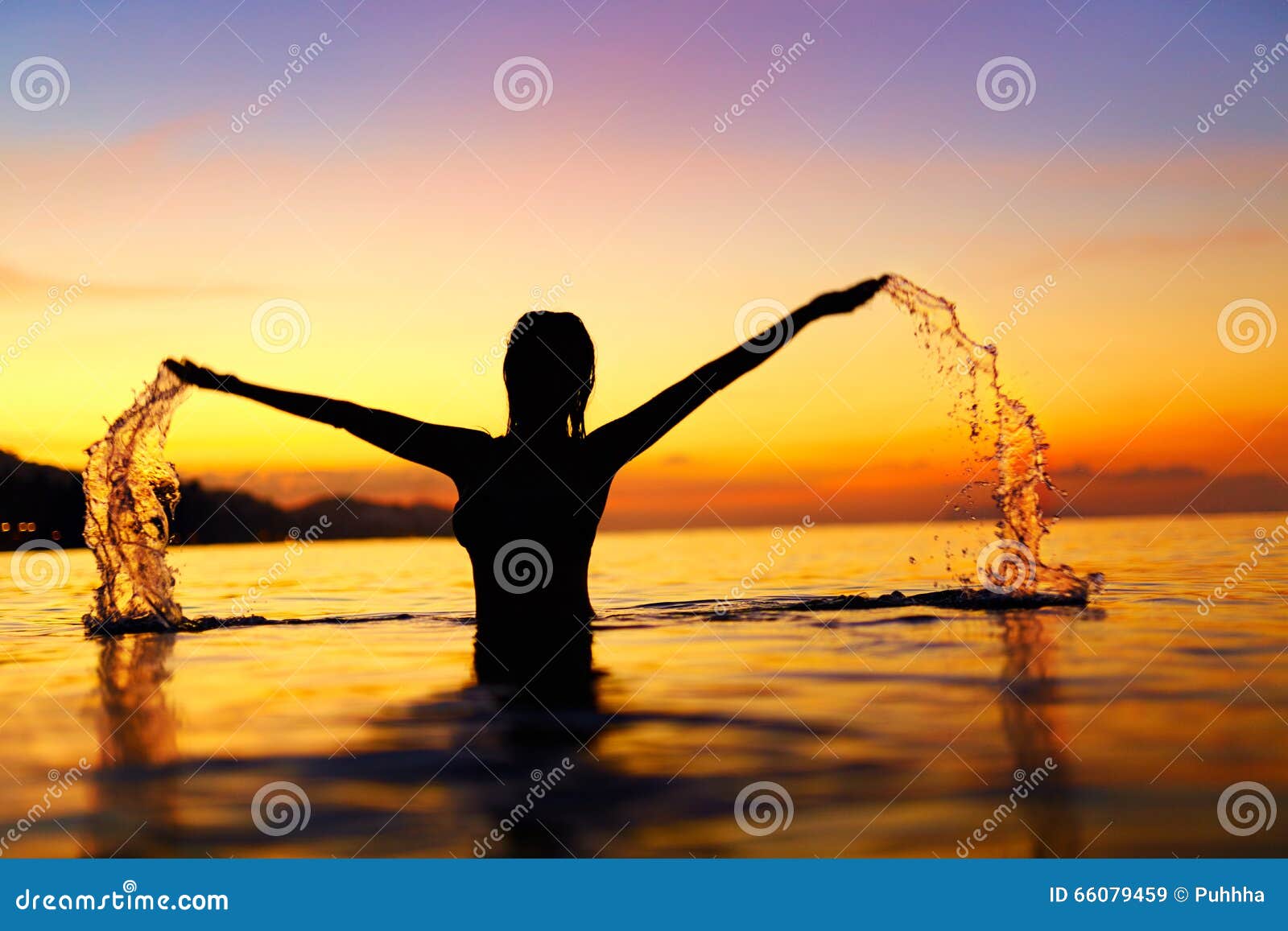 freedom, enjoyment. woman in sea at sunset. happiness, healthy l