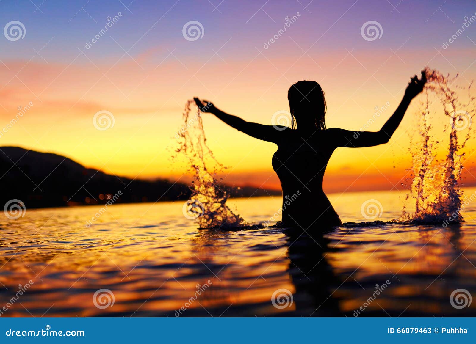 freedom, enjoyment. woman in sea at sunset. happiness, healthy l