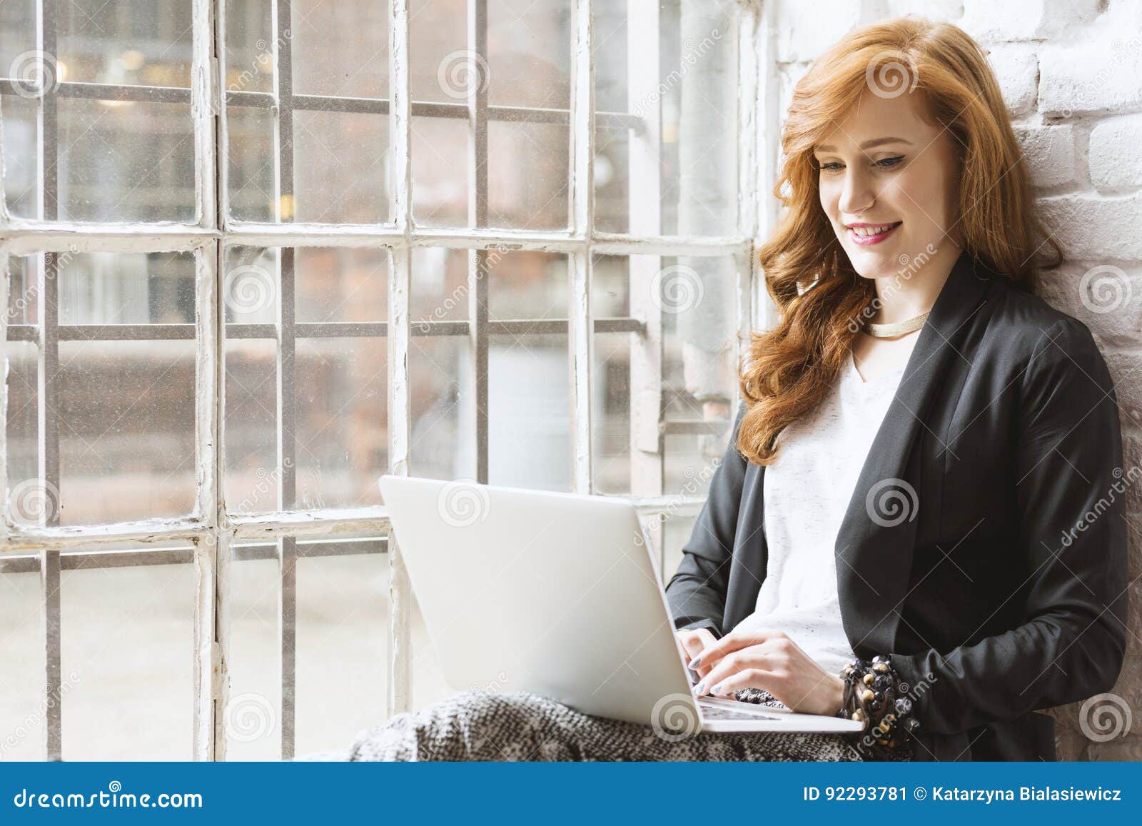 freelance copywriter sitting on windowsill