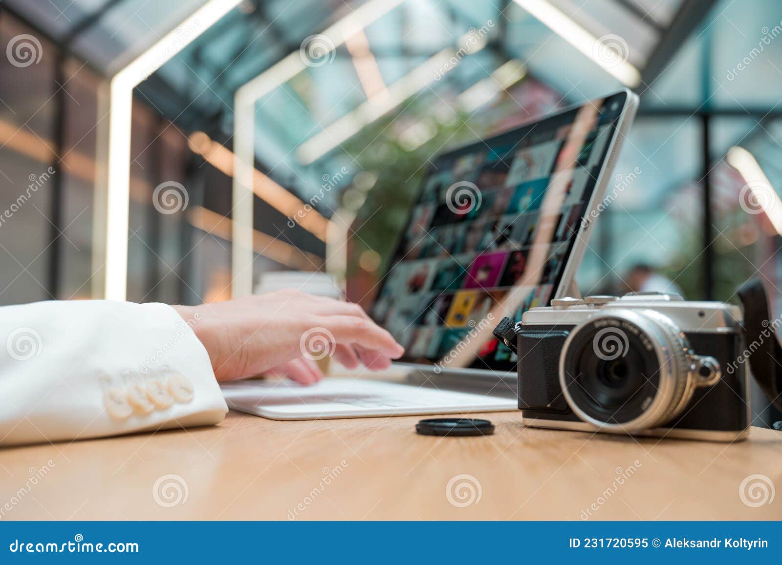 A Freelance Photographer Works Remotely, a Thin Mobile Computer with a