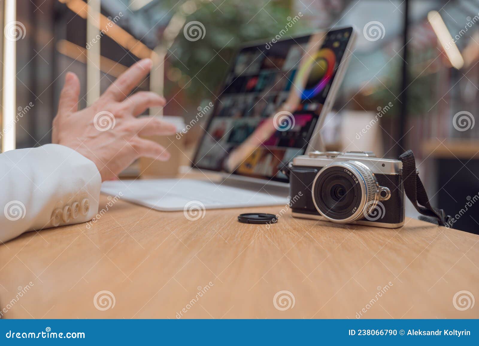 A Freelance Photographer Works Remotely, a Thin Mobile Computer with a