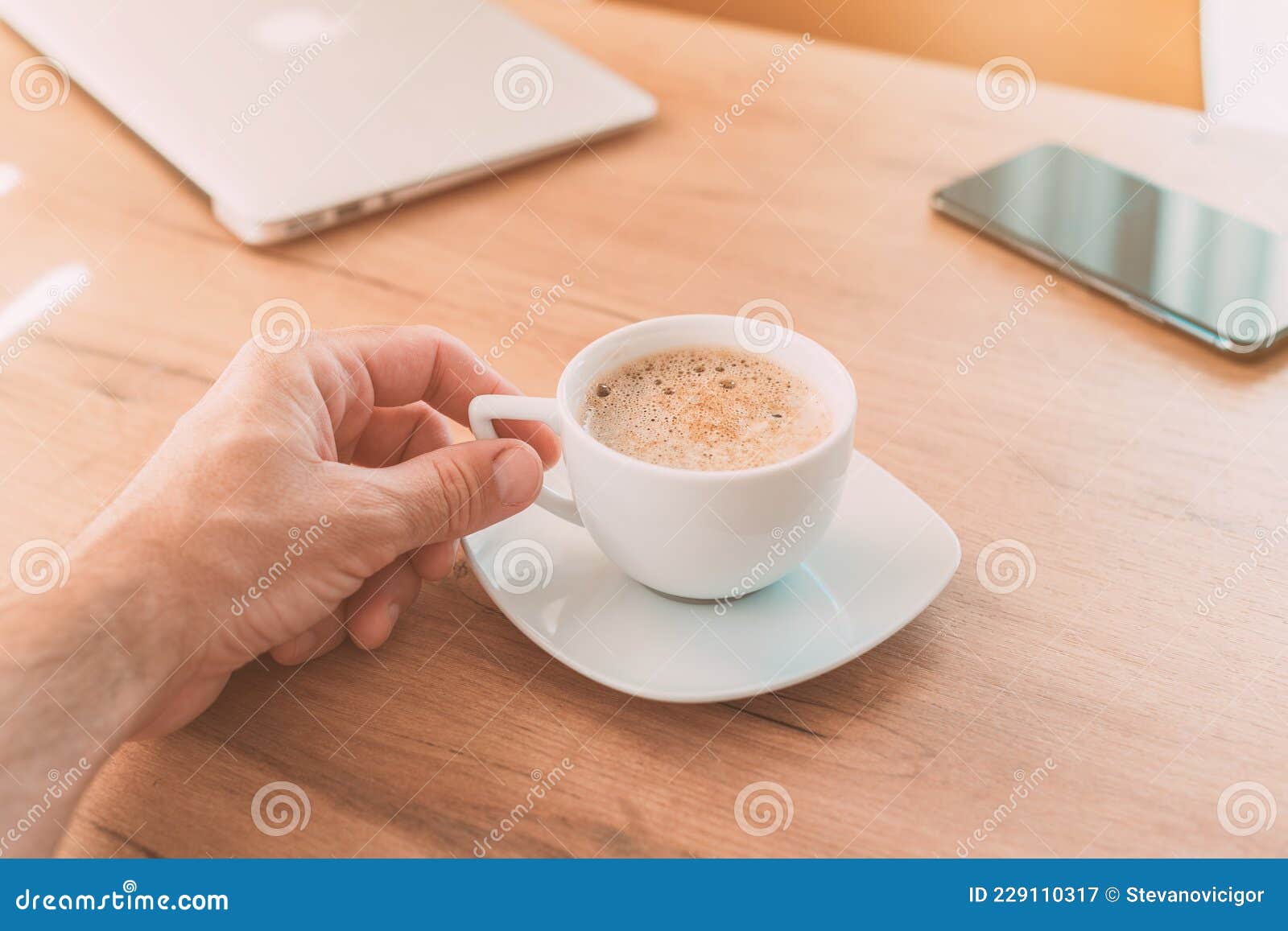 Freelancer Drinking Coffee at Home Office before Getting To Work Stock
