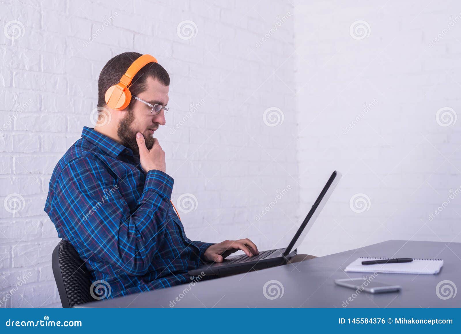 Freelancer Working on a Laptop in Bright Headphones, Remote Work Stock