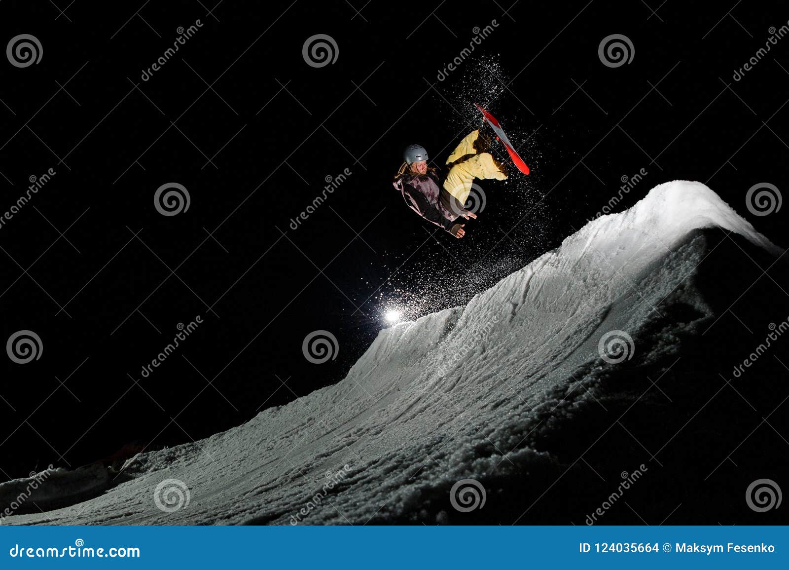 Freeride Snowboarder with Dreadlocks is Jumping in Powder Snow at Night ...