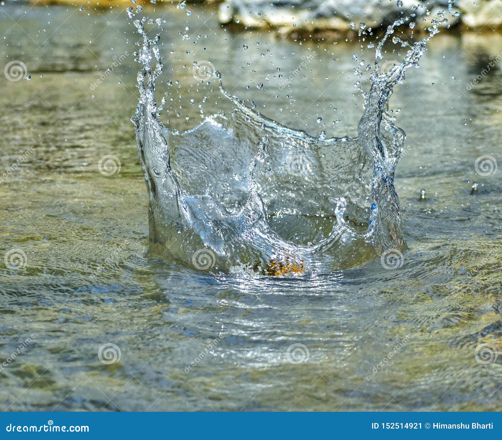 a  freez shot of a stone getting splashed in water