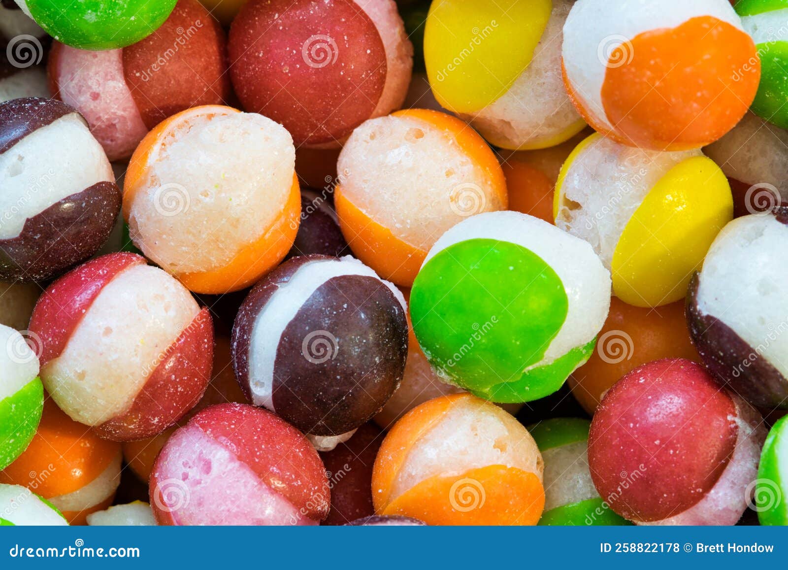 freeze dried skittles hard candy macro with splits through their centers.