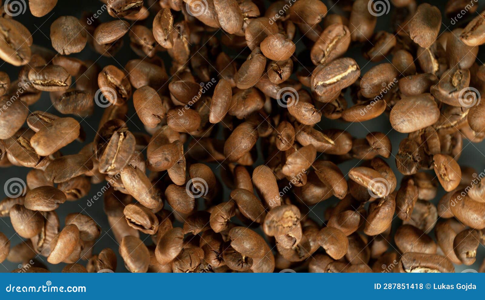 Freeze Motion Shot of Flying and Rotating Coffee Beans Stock Photo
