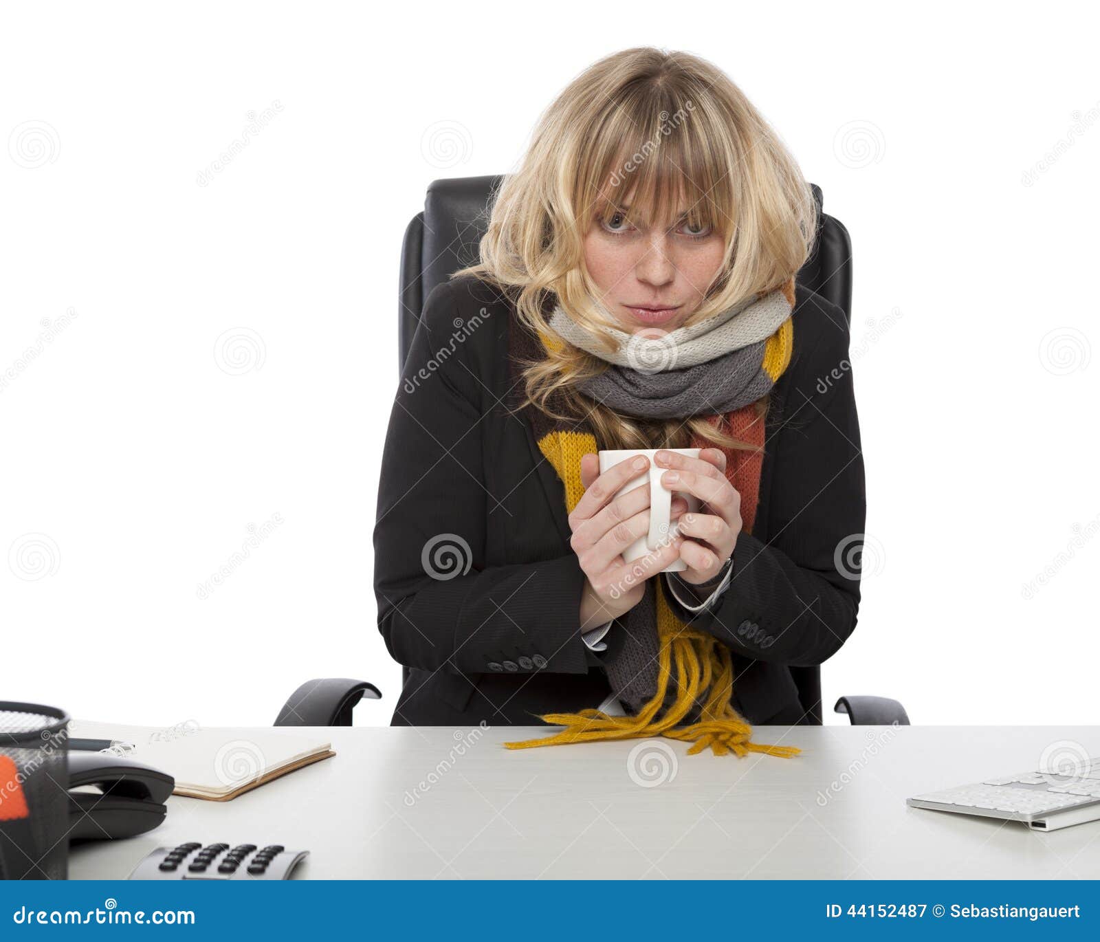 freezing businesswoman warming up with coffee