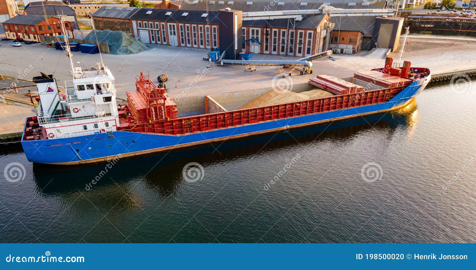 Freight Ship Loading Grains at an Industrial Port. Editorial Image