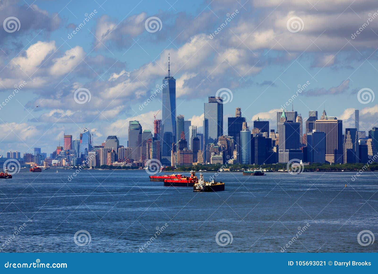 freighters in harbor with new york city in background