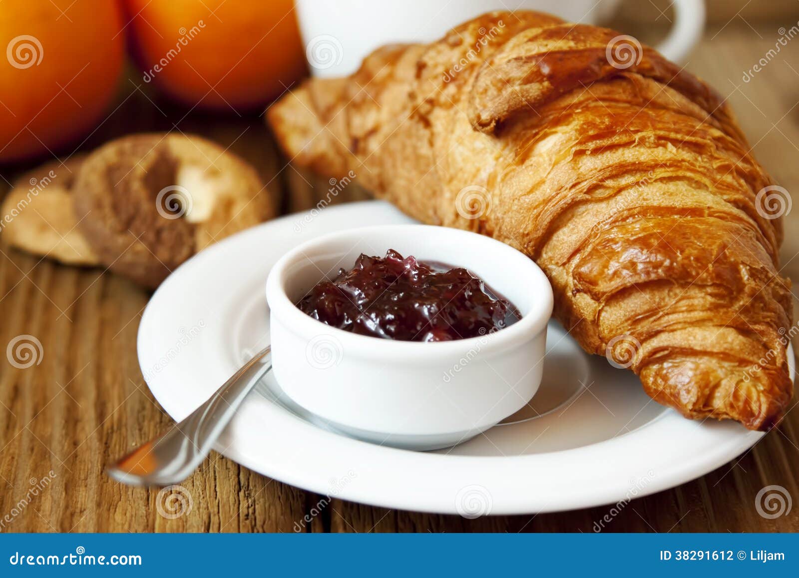 French breakfast with croissant, berries, jam and black coffee