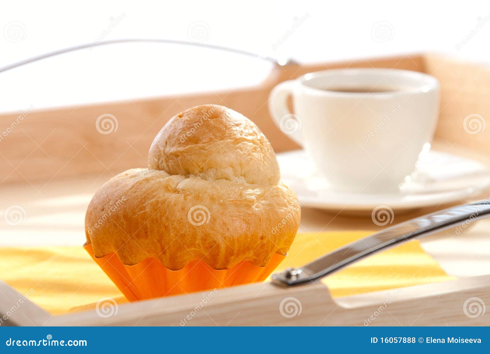 french brioche and white cup of coffee