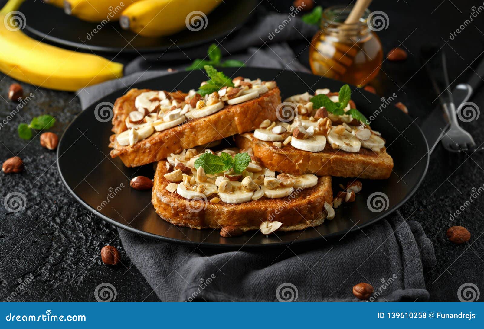 French Cinnamon Toast with Banana, Nuts and Hazelnut, Honey. Stock