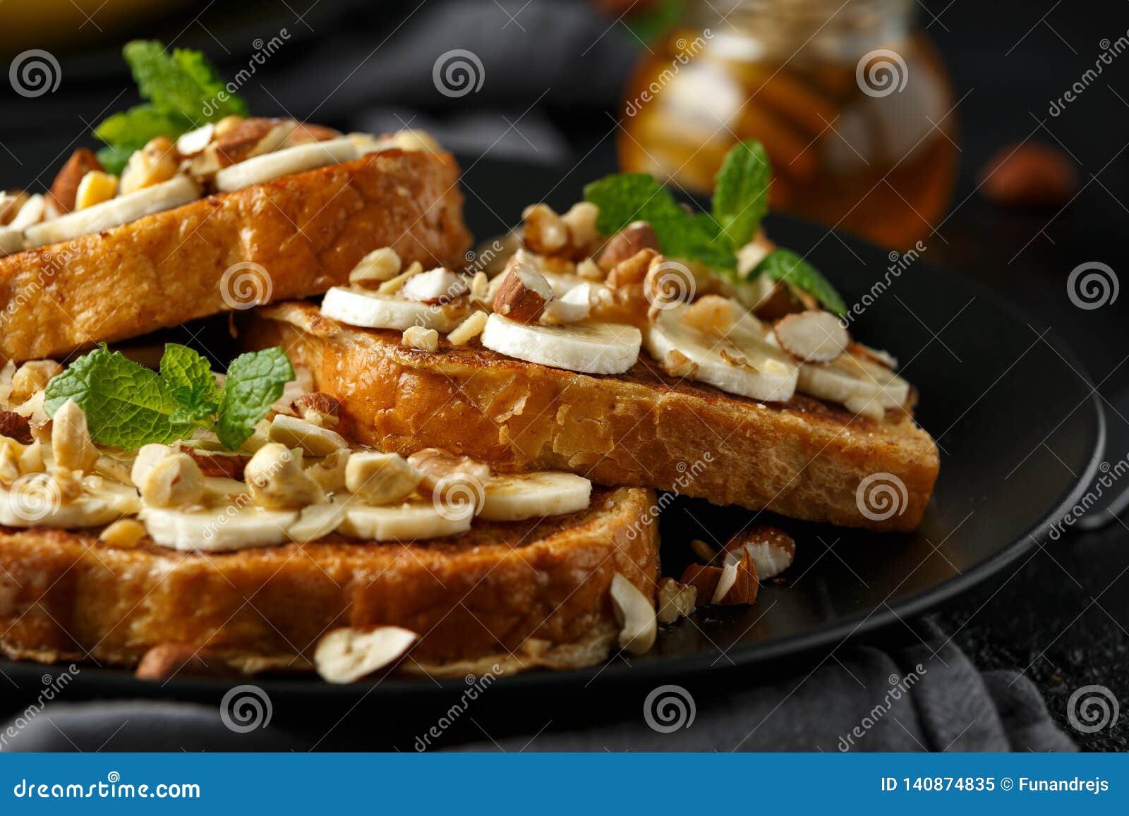 French Cinnamon Toast with Banana, Nuts and Hazelnut, Honey. Stock