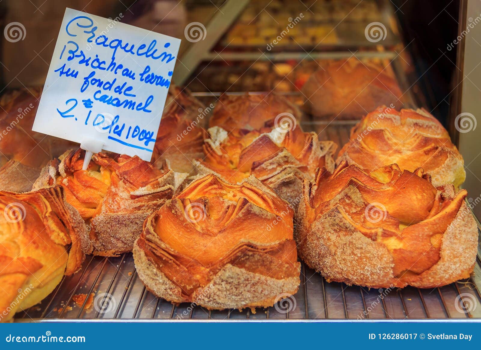 french craquelin sugary brioche with a crispy top and caramel filling at a bakery in cannes france