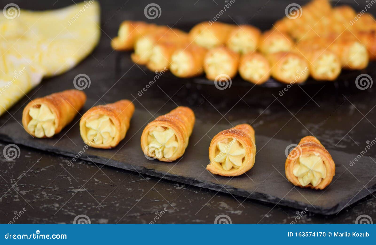 French Cream Horn. Puff Rolls with Cream on a Dark Background Stock