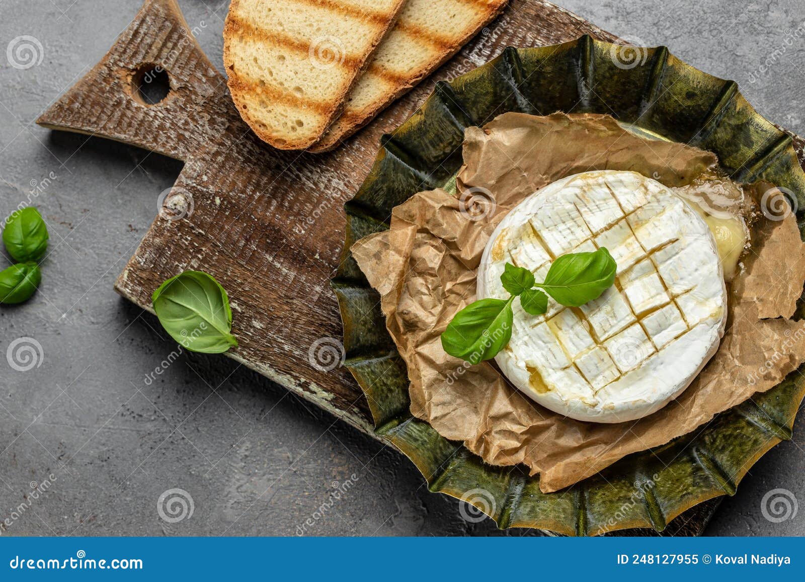 French Cuisine. Baked Camembert Cheese with Cranberries and Basil