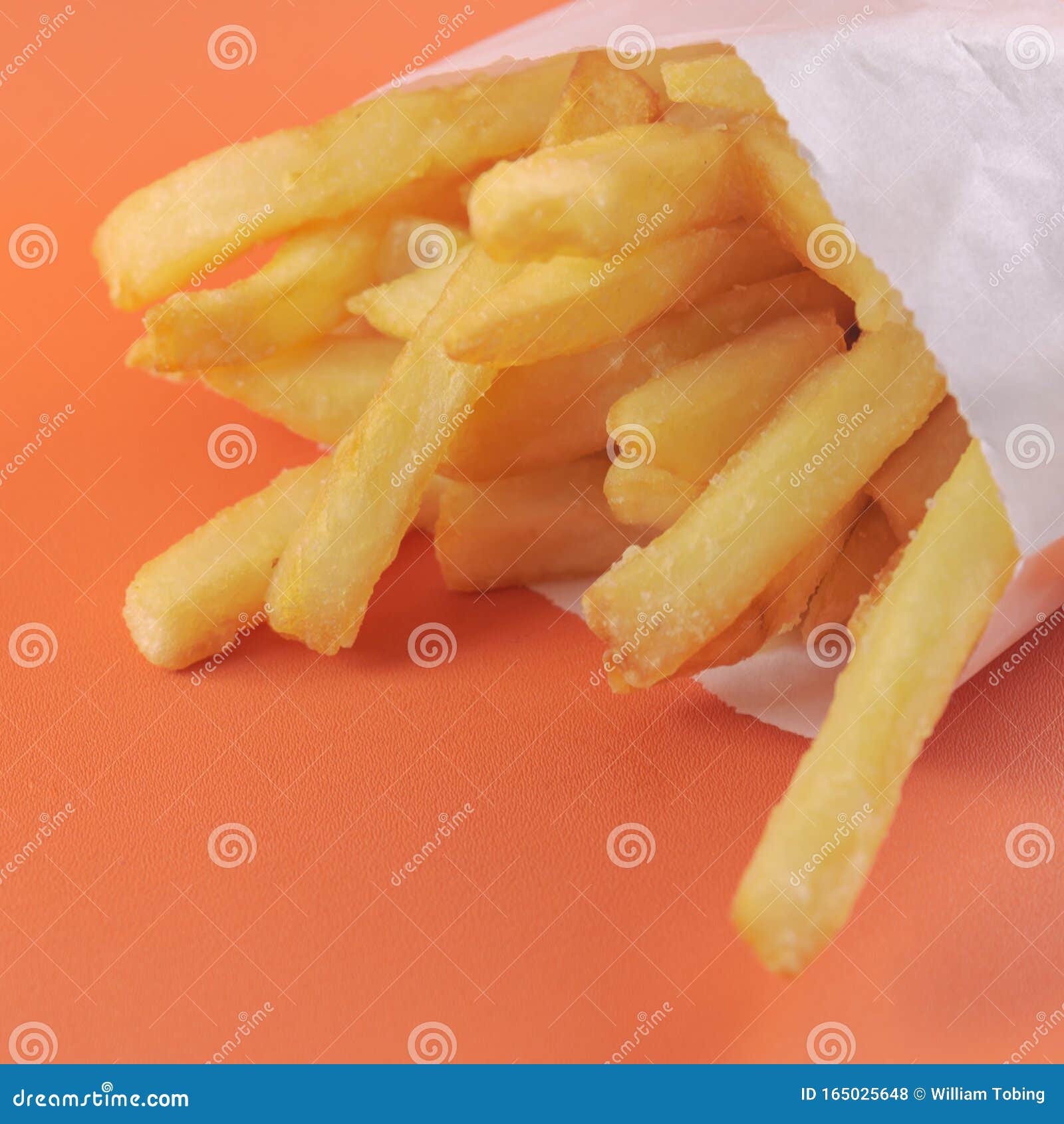 French Fries In The Paper Bag Isolated On White Stock Photo