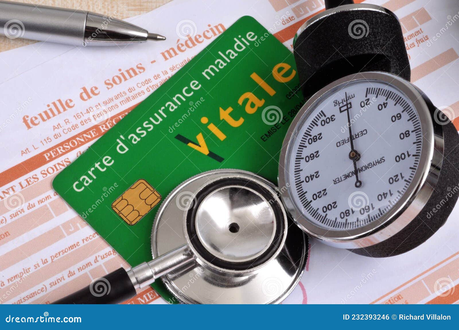 French Health Insurance Card Lying On A Working Care Sheet Next To french-health-insurance-card-lying-on-a-working-care-sheet-next-to