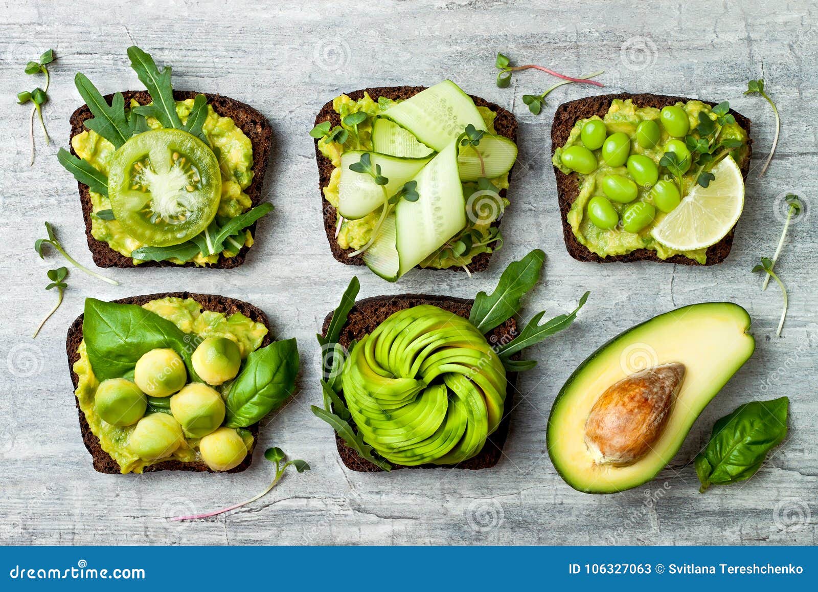 fresh avocado toasts with different toppings. healthy vegetarian breakfast with rye wholegrain sandwiches.