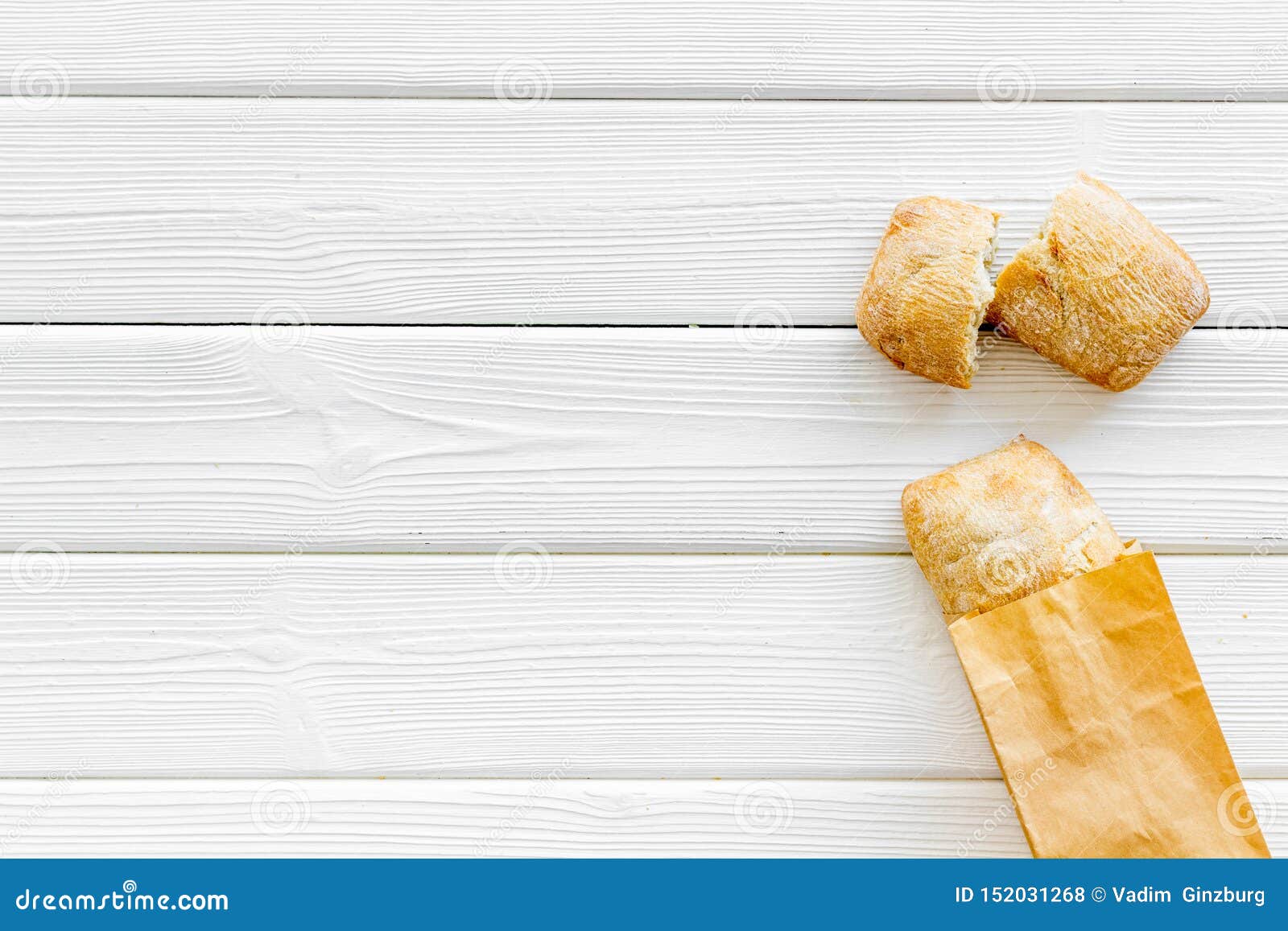 Download Fresh Baguette And Paper Bag For Bakery On White Wooden ...