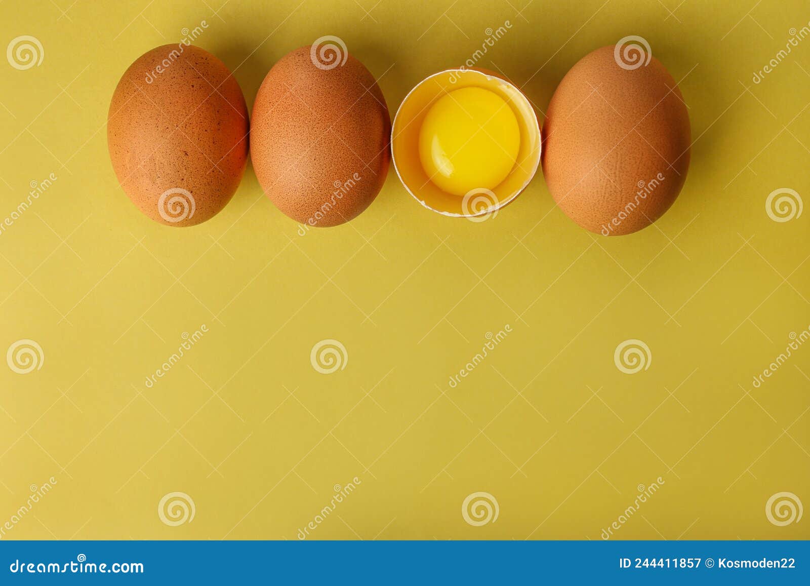 Fresh Brown Eggs and a Broken Egg with Yolk on a Light Yellow