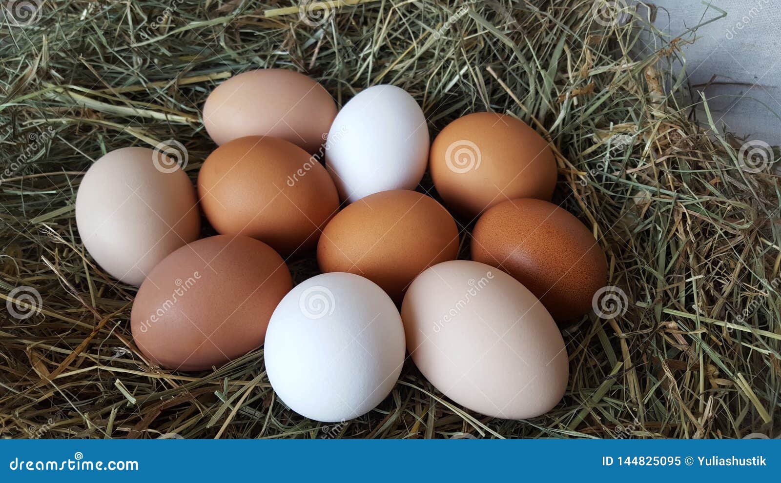 fresh chicken eggs of different colors lie in a pile on the hay. farming and household. preparation for easter. farm lifestyle in