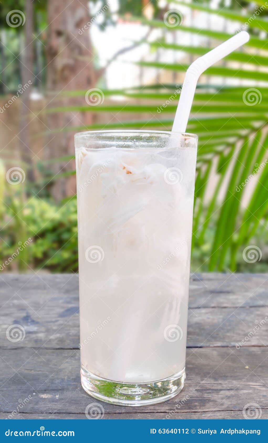 Fresh Coconut Water in a Glass Placed on a Wooden Table Stock Photo