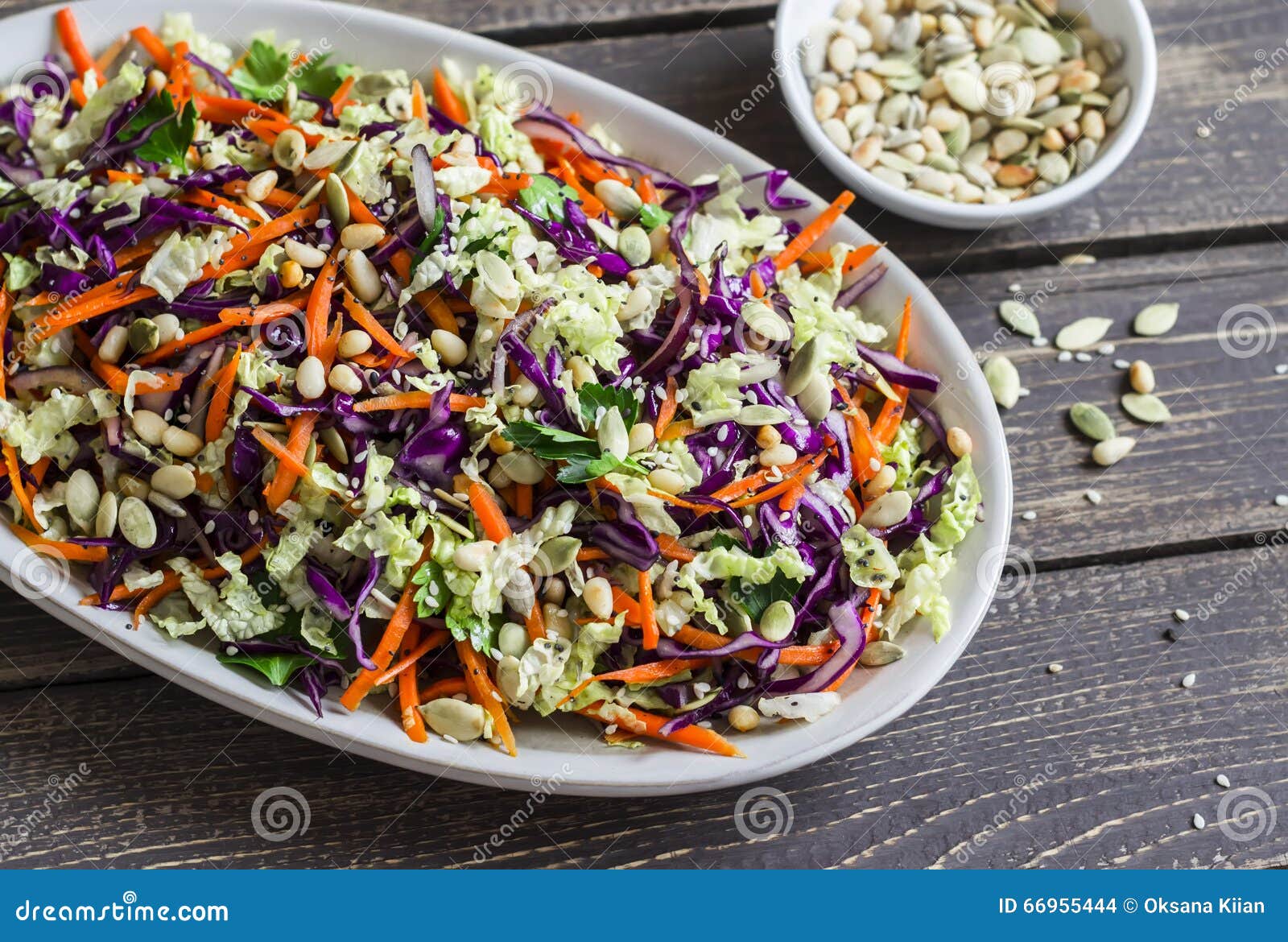 fresh cole slaw with pumpkin, flax, sesame seeds and pine nuts - delicious healthy vegetarian food.