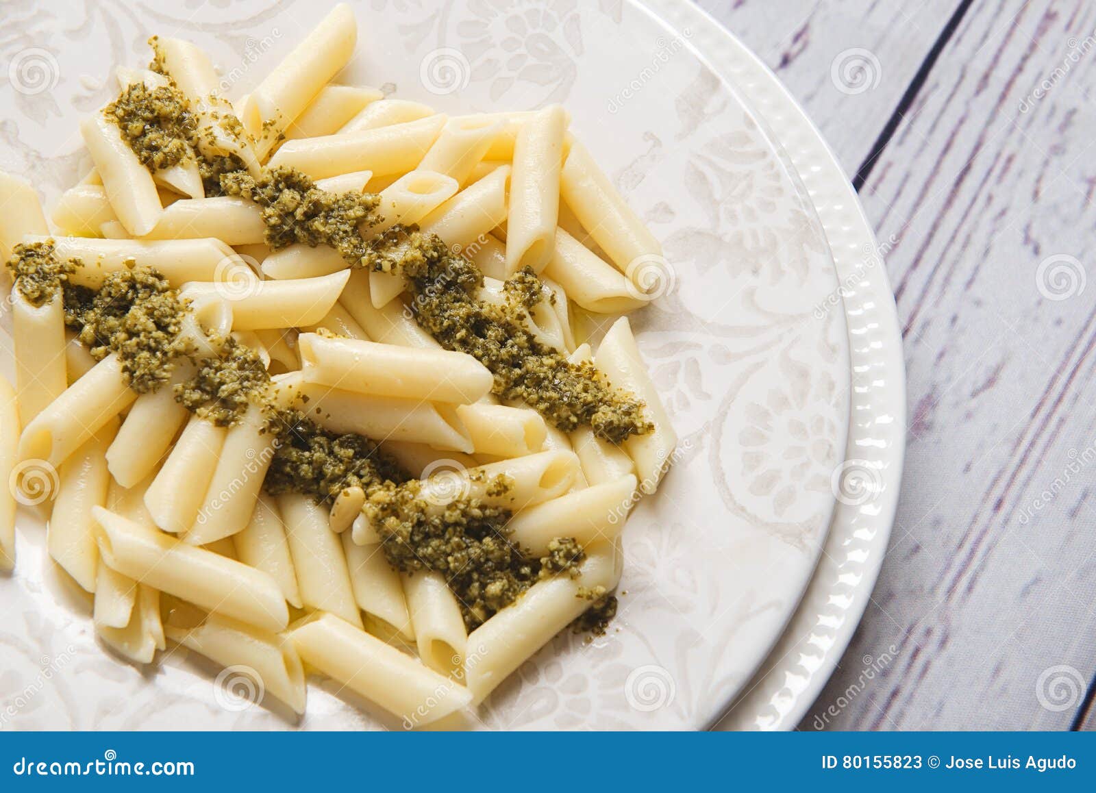Fresh Cooked Pasta with Sauce Served on White Plate with Fork and Knife