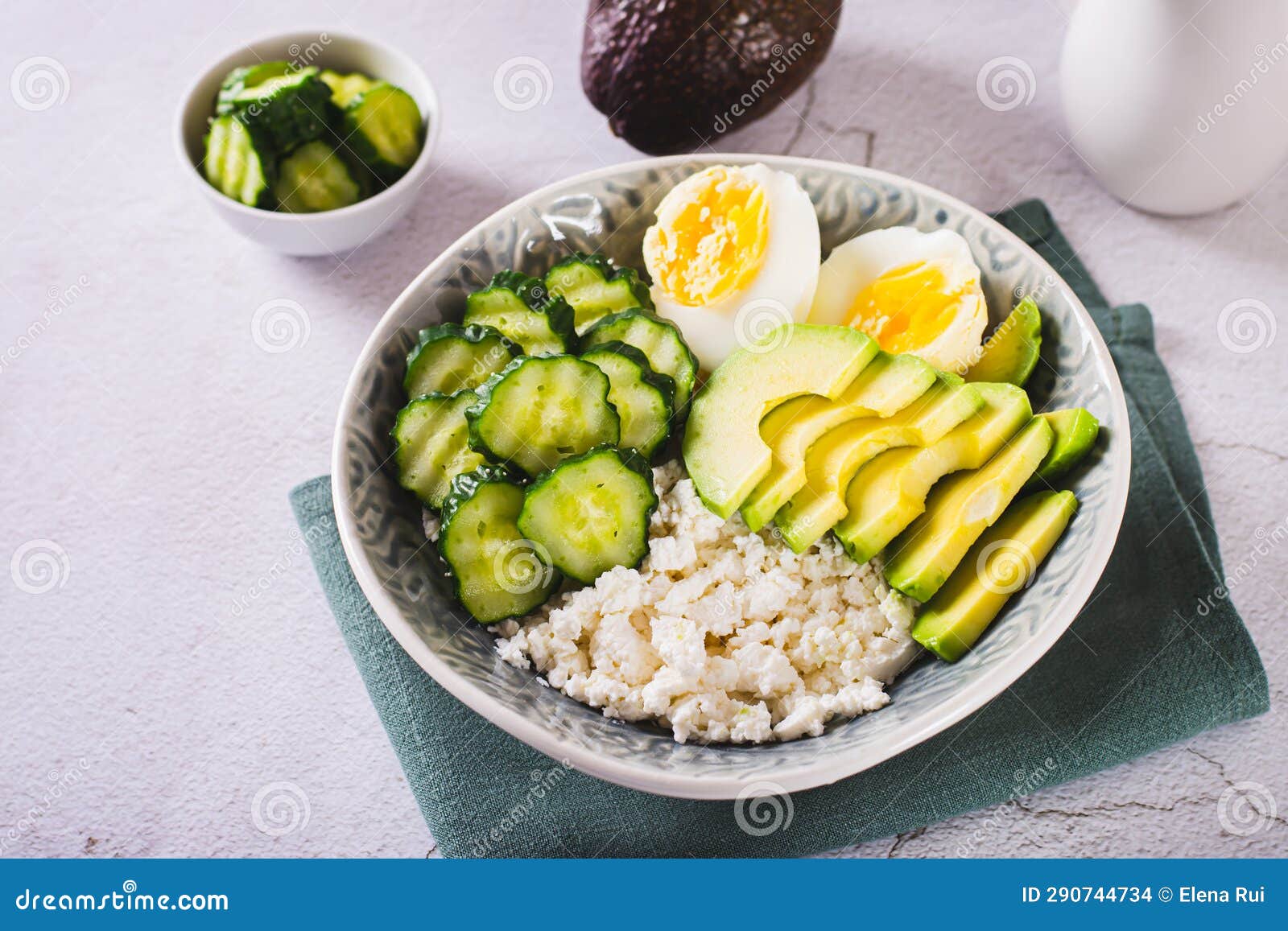 Fresh Cottage Cheese, Avocado, Cucumber and Boiled Egg in a Plate Stock