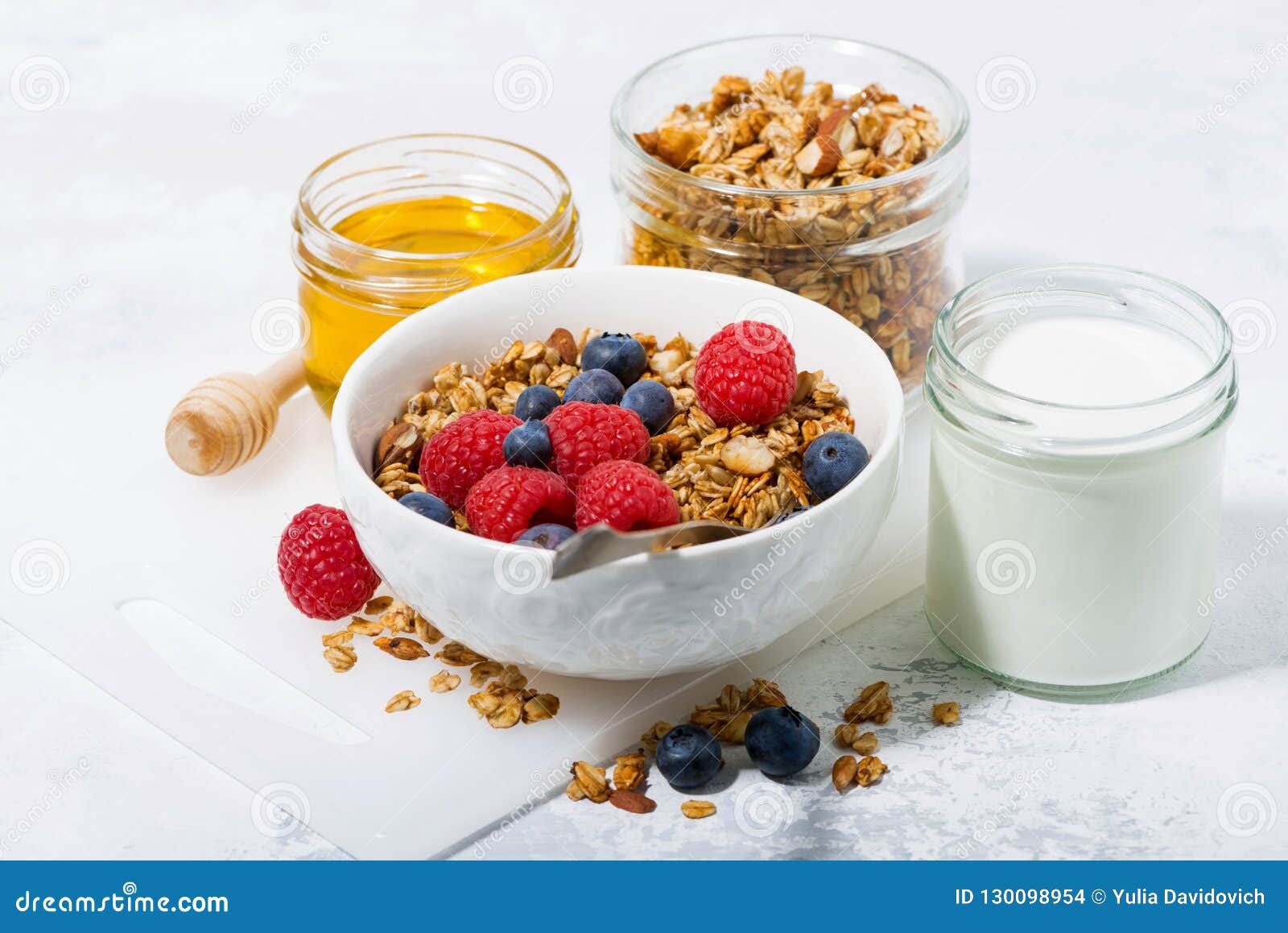 Fresh Cottage Cheese with Granola and Honey on White Table Stock Photo