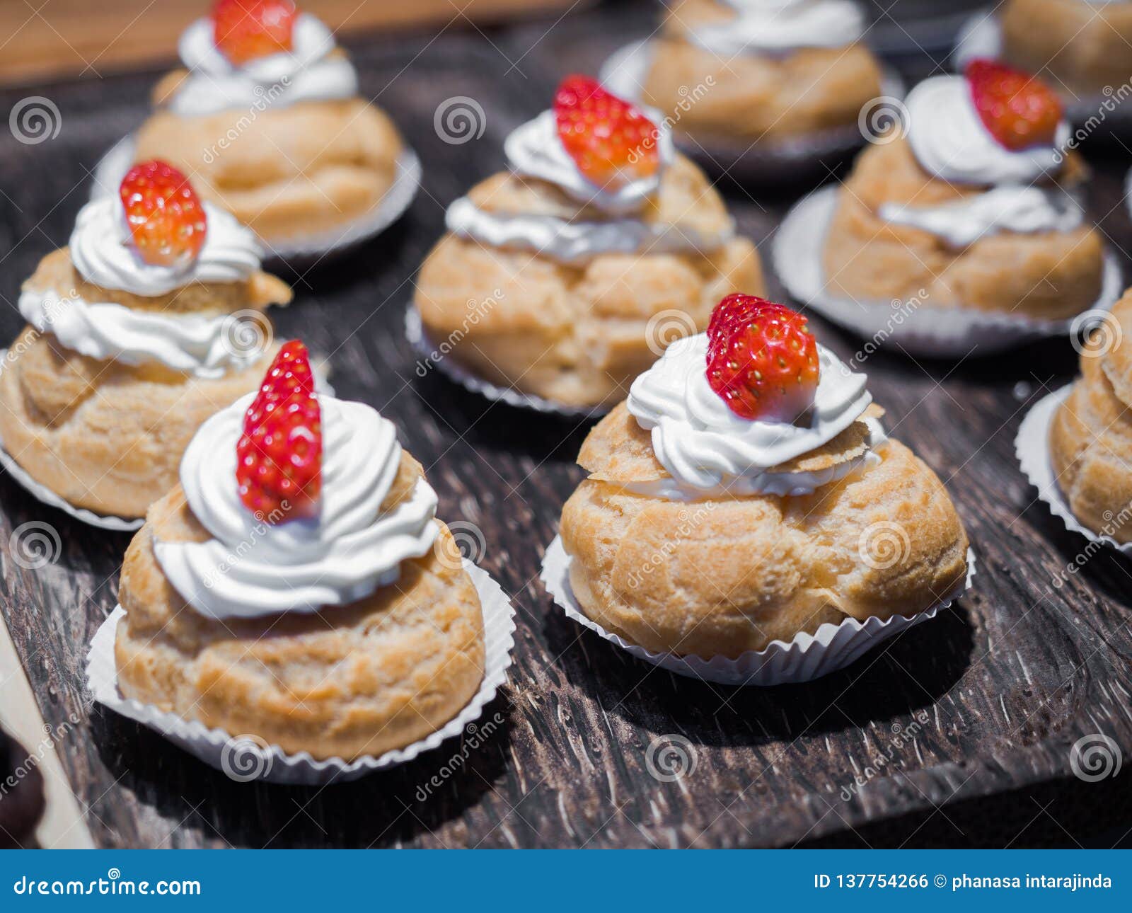 Fresh Cream Puffs Filled with Whipped Cream and Strawberry on Top ...