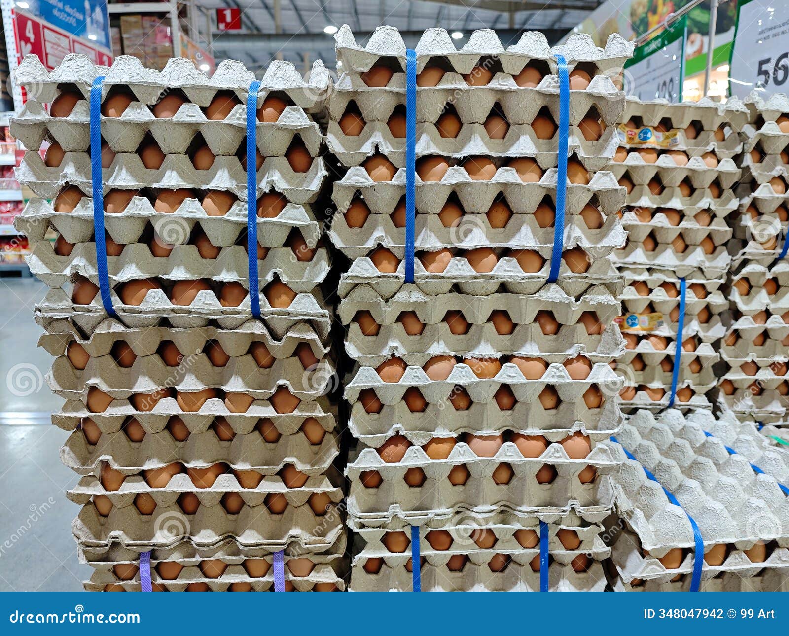 fresh eggs stacked neatly in cardboard cartons at grocery store