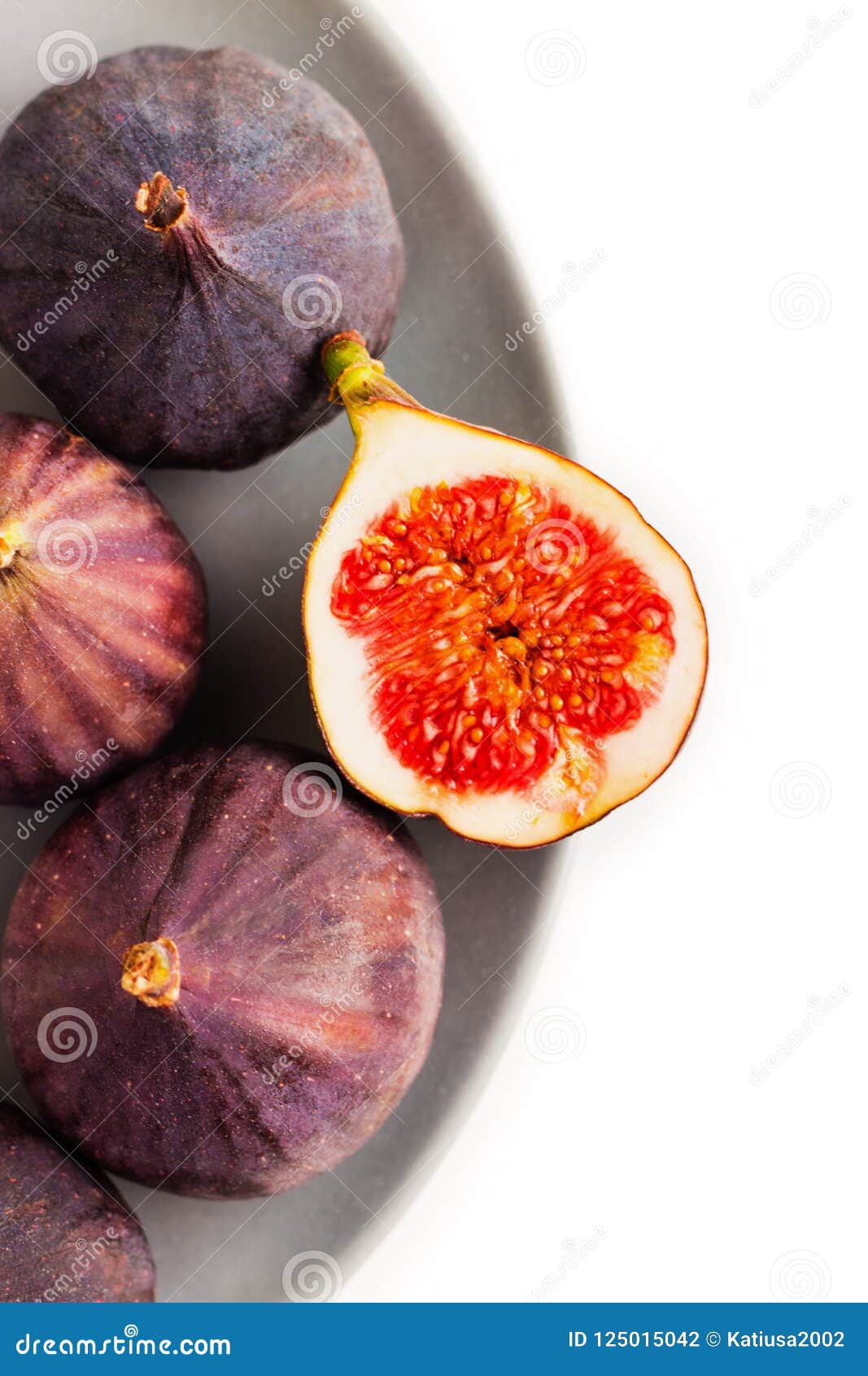 Fresh Figs on Grey Plate. Fruit with Half on White. Stock Photo Image