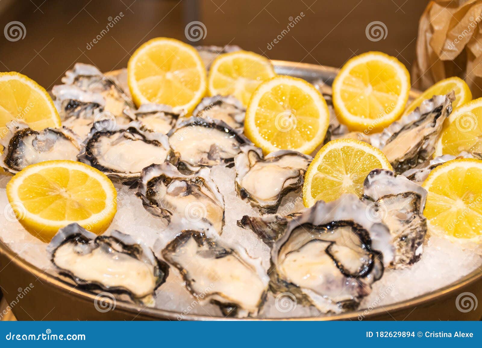 fresh fine de claire oysters served with lemon`s slices in ice, durign brunch buffet